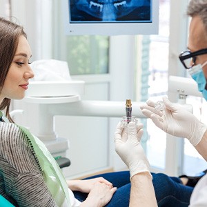 A woman at a dental implant consultation with her dentist