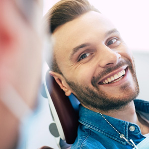 Man smiling at dentist in treatment chair