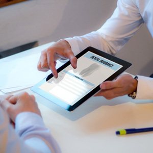 Patient looking at dental insurance form on tablet