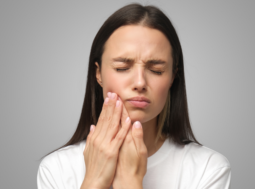 Woman holding jaw in pain